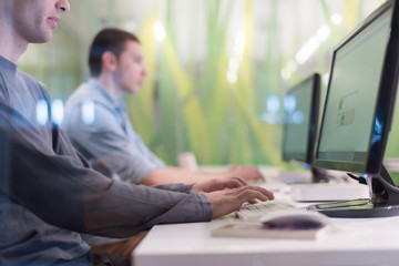 technology students group working  in computer lab school  class