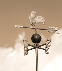  weathervane with rooster above an arrow and the four cardinal p - obrazy, fototapety, plakaty