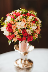 flower bouquet in glass vase on wood table grunge wall