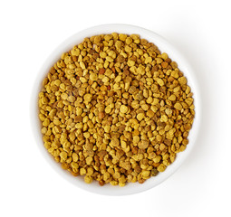 Bowl of bee pollen isolated on white, from above