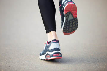 Plakat Close-up of runner woman feet. Back view