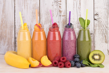 Fototapeta na wymiar Fruit smoothies variety in rainbow colors