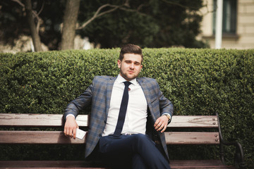 Obraz premium Handsome stylish young businessman posing portrait outdoor