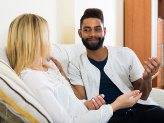 Obraz premium Happy young people sitting indoors and talking