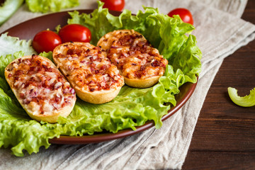 mini baguettes with ham, onion, peppers, lettuce and cherry tomatoes