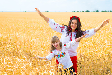 Mom and daughter in wheat field