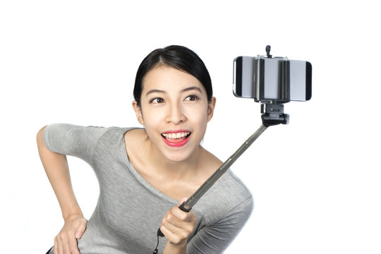 Happy woman with smartphone selfie stick 1