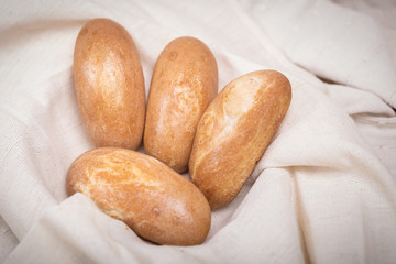 Fresh homemade bread in a cotton cloth background