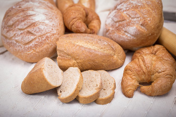 Fototapeta na wymiar Fresh homemade bread in a cotton cloth background