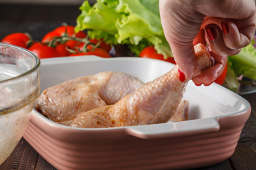 raw chicken legs and marinade ingredients on the kitchen board