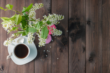 Delicious macaroon with beautiful flowers on wooden background