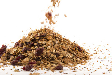 Pile of Granola cereal with raisins on white