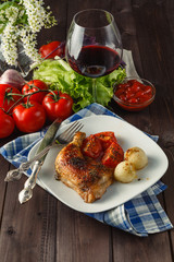 roasted chicken leg with orange and rosemary, top view