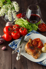 roasted chicken leg with orange and rosemary, top view