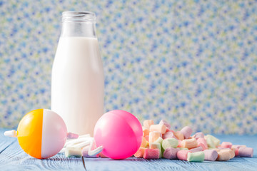 marshmallow and white cbottle of milk on table