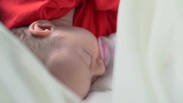 Beautiful infant baby girl in bed sleeping
