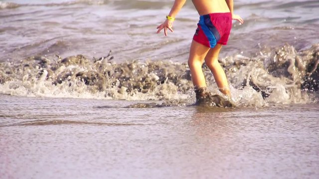 Kid playing in the beach
