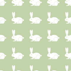 Vector seamless pattern with rabbits on green background.