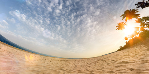 Sunny beach wide angle panoramic view blue sky