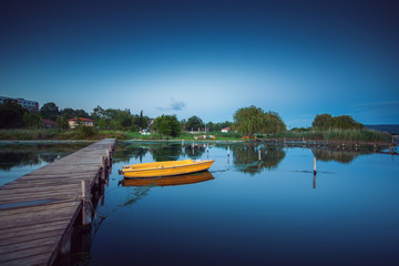 Fototapeta na wymiar Small Dock and Boat at the lake