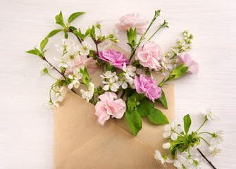 Naklejka na ściany i meble Colorful spring flowers in envelope, flower delivery concept