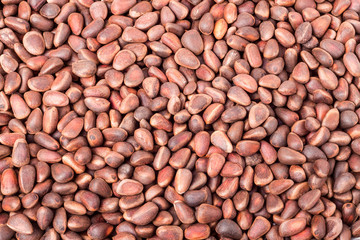 unpeeled pine cedar  nuts as a background