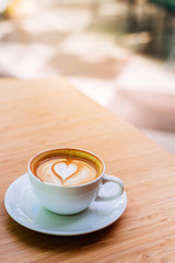 hot coffee on wood background at coffee shop