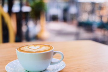 hot coffee on wood background at coffee shop