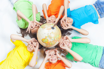 Group of international funny kids with globe earth