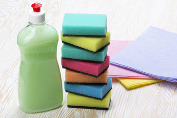 sponges, rags and a bottle of detergent