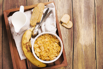 Tasty and healthy breakfast on wooden tray