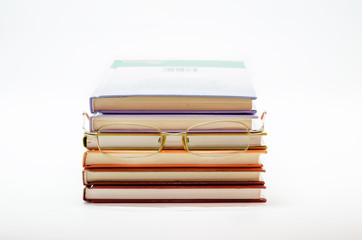 Stack of books with glasses