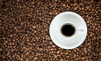 Coffee cup with roasted beans background