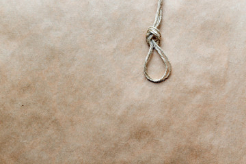 concept hangman's knot on kraft paper background soft light