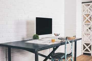 Designer desk on white brick