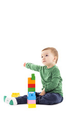 Cute little boy playing with colorful blocks