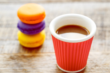 coffee break with macaroon on wooden table