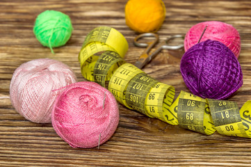Embroidery threads with scissors and measuring instrument on the