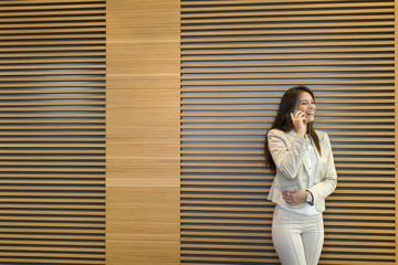 Young woman with mobile phone in the office