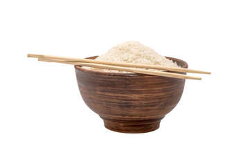 Bowl of raw rice with chopsticks isolated on white
