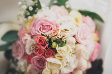 Pretty good wedding bouquet of various flowers with rings