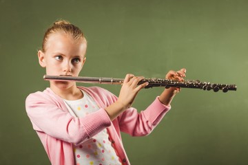 Girl playing the flute © WavebreakmediaMicro