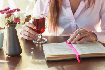 Woman's hands with a book