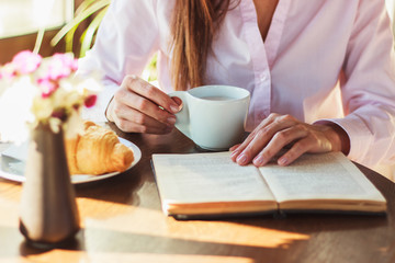 Woman's hands with cup of coffee