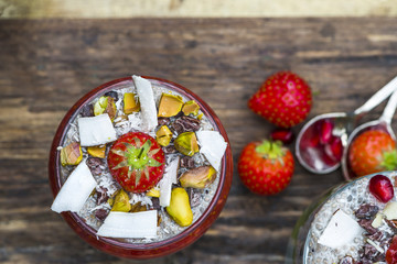 Chia seed pudding layered with fruit and strawberry sauce