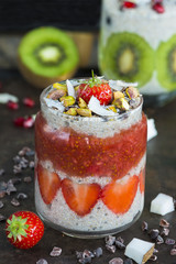 Chia seed pudding layered with fruit and strawberry sauce