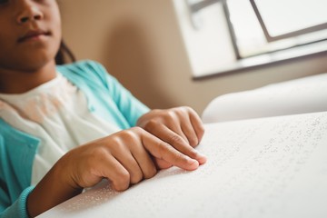 Girl using braille to read