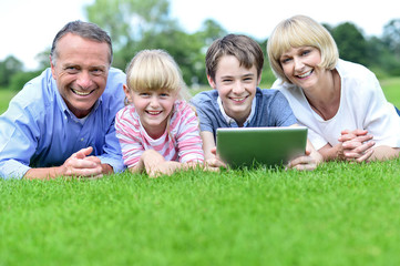 Fototapeta premium Happy family enjoying time at grass