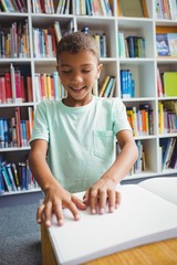 Boy using braille to read - obrazy, fototapety, plakaty