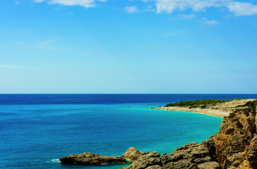 Fototapeta na wymiar View of beautiful beach with rocky cliffs at mediterranean sea